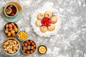 top view cup of tea with nuts and candies on the white background nut tea candy snack