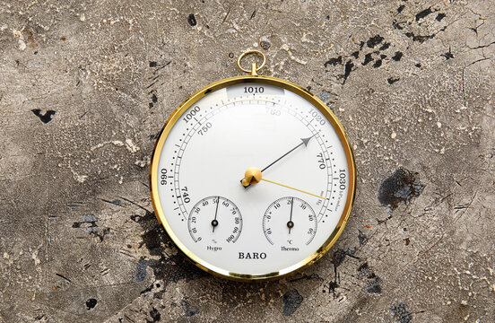 Aneroid barometer on grey grunge background