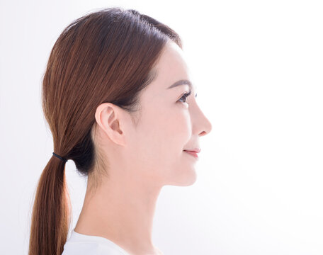 Side view of Beautiful young asian woman with clean fresh skin on white background