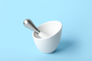 Mortar and pestle on blue background