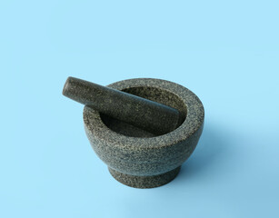 Mortar and pestle on blue background