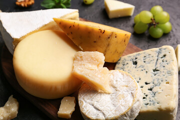 Different types of tasty cheese on table, closeup