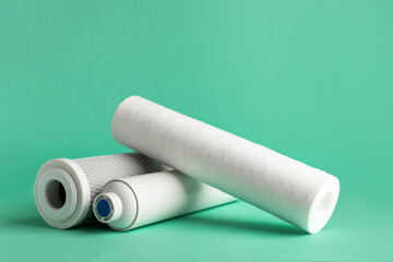 New water filter cartridges on green background