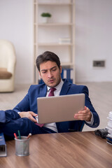 Young male employee unhappy with excessive work in the office