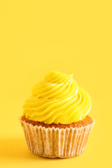 Tasty cupcake on yellow background