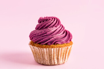 Tasty cupcake on purple background