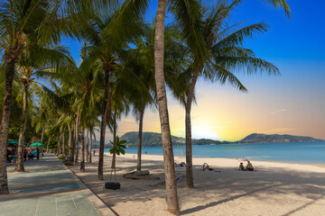 Patong Beach Phuket Thailand nice white sandy beach clear blue and turquoise waters and lovely blue skies with Palms tree sunset sunrise