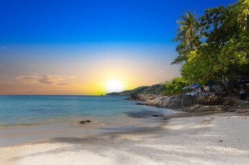 Patong Beach Phuket Thailand nice white sandy beach clear blue and turquoise waters and lovely blue skies with Palms tree sunset sunrise