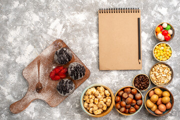 top view delicious chocolate balls cakes with nuts on white floor cake biscuit sugar cookie sweet tea