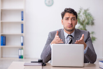 Young male employee working in the office