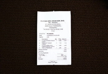 Paper sales receipt isolated on a dark background. proof of purchase concept