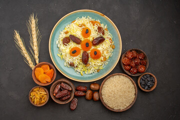 top view delicious cooked plov rice with different raisins inside plate on grey desk rice meal food dinner raisin cooking
