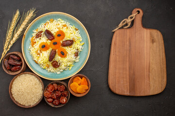 top view delicious cooked plov rice with different raisins inside plate on the grey background rice meal dinner food cooking raisin