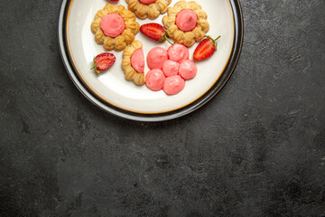 top view delicious little cookies with pink cream inside plate on grey background cookie biscuit sugar tea cake sweet
