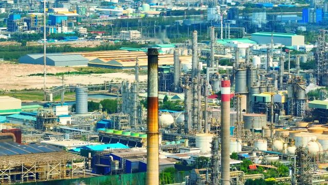 The smoke that is often seen rising from refineries and petrochemical plants is a byproduct of the refining process, and is typically composed of various gases and particulate matter. Drone. 4K UHD

