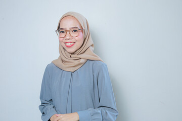 Fototapeta premium Happy beautiful young asian muslim business woman wearing glasses over isolated background