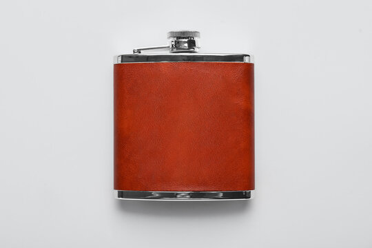 New hip flask on grey background