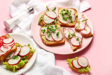 Plates with delicious radish bruschettas on pink background