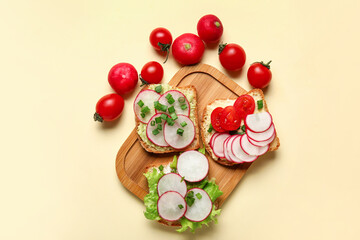 Board with delicious radish bruschettas on beige background