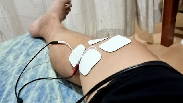 Patient receiving interferential therapy as part of the physiotherapy course to heal injured ankle foot