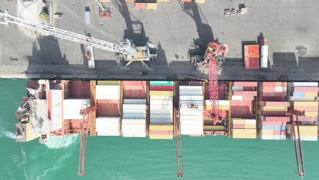 Freight container ship in Cape Town harbour loaded with reefer and dry containers overhead view
