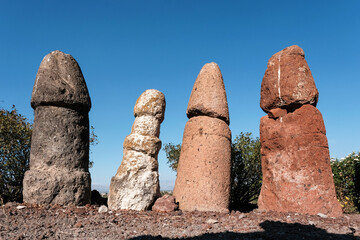 Ancient stone phallic symbols in Metsamor Archeological Site on sunny summer day. Taronik, Armavir Province, Armenia.