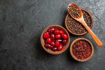top view fresh red dogwoods with seasonings on grey background spicy hot fruit fresh ripe