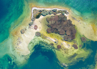 Fototapeta premium Aerial top view of an island on Sevan lake on sunny summer day. Norashen Reserve, Gegharkunik Province, Armenia.