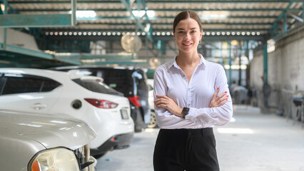 Portrait of young beautiful caucasian woman smiling in auto repair shop . concept of auto repair and maintenance service.