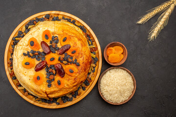 top view shakh plov delicious rice meal cooked inside round dough with raisins on dark grey background rice cooking dough food dinner meal