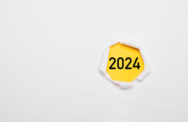 2024 year on yellow paper and inside of white punch paper for Preparation of Merry Christmas and...