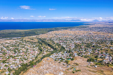 Aerial view of Nerkin Getashen village, Martuni town and Sevan lake on sunny summer day. Gegharkunik Province, Armenia.