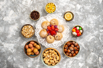 top view sweet candies with nuts cookies on white background nut snack sweet sugar