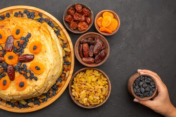 top view tasty shakh plov cooked rice inside round dough with raisins on grey background food dough rice meal cooking cuisine