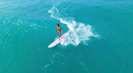 Fototapeten Black female surfer riding a wave © Nikita