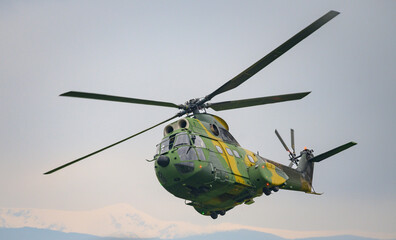 Military helicopter on mission. Helicopter in camouflage.