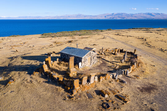 Drone view of Surb Gevork church on Sevan lake shore on sunny summer evening. Gegharkunik Province, Armenia.