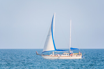 Sailing yacht in the blue calm sea.