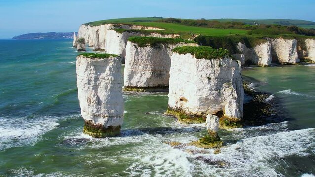 Aerial shot of Old Harry Rocks and coastline with rough seas, Dorset, UK