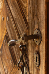 Stara klamka w drewnianych, otwartych drzwiach