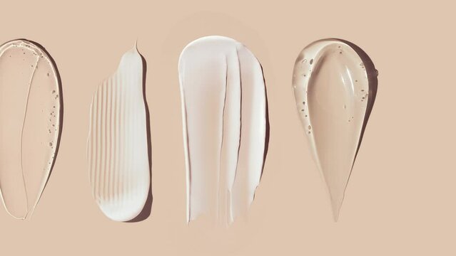 cosmetic smears of creamy texture on beige background