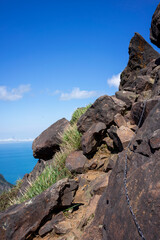The steep via ferrata to the top of Teapot mountain. A rocky trail leads up the mountain with a metal chain as a guide.