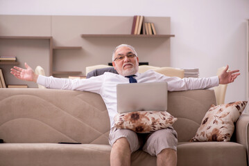 Old male employee working from home during pandemic