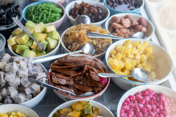 Close-up view of slices of pineapple and lotus root in glazed syrup and a variety.