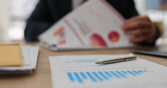 Businessman is studying financial statistics of business in charts. Analytics and business development planning
