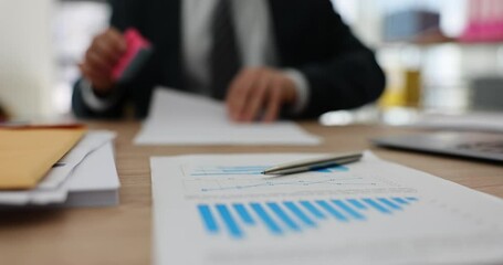 Closeup of businessman's hand stamping document. Financial report or stamp approved loan decision