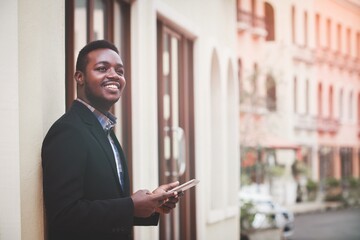 Handsome african businessman in suit holding digital tablet. Leadership executive business guy get successful of business. Male get confidence. Professional businessman thinking about new project