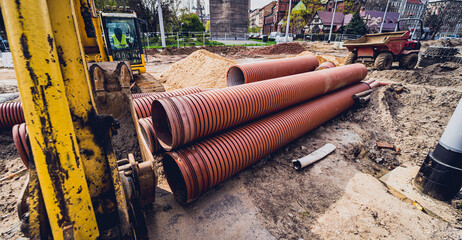 Big construction site with pipes and wires in the construction area.