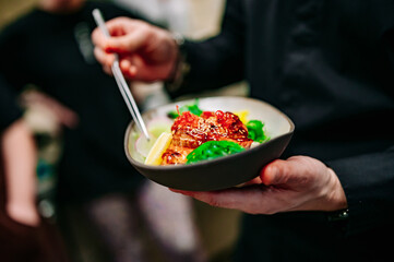 chef hand cooking donburi food in the restaurant kitchen