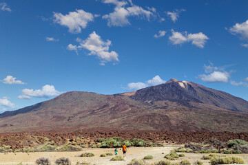 The famous El Teide volcano in Tenerife, Canary islands, Spain. Volcanic landscape in front a blue sky and white clouds.